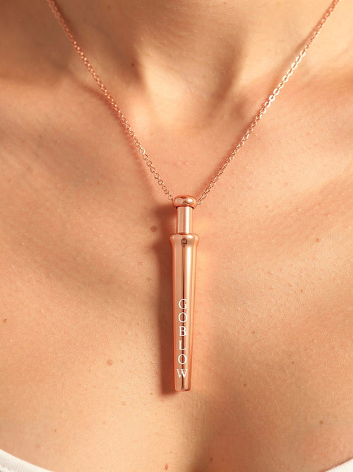 GoBlow Rose Gold pendant — editorial chest warm sunlight worn
