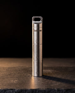 GoBlow Stacks Triple — closed, dark hero — machined stainless EDC capsule pendant