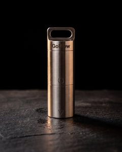 GoBlow Stacks Double — closed, dark hero — machined stainless EDC capsule pendant
