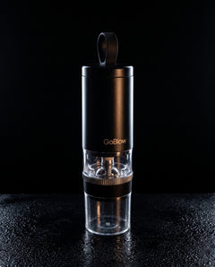 GoBlow Precision Device rim-lit silhouette — machined stainless EDC capsule pendant