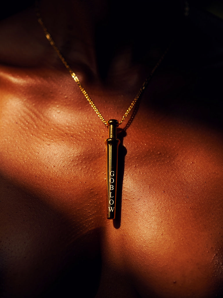 GoBlow Gold pendant — editorial collarbone close-up glistening skin