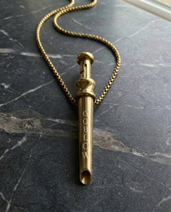 GoBlow Pendant MKII in Gold, on marble — machined stainless EDC capsule pendant