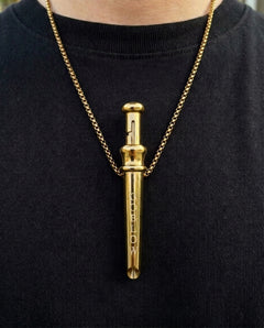 GoBlow Pendant MKII in Gold, worn on the chest — machined stainless EDC capsule pendant