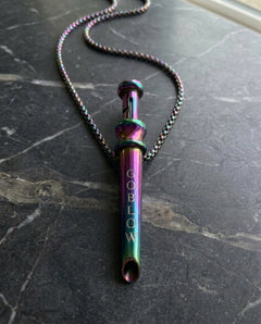 GoBlow Pendant MKII in Rainbow, on marble — machined stainless EDC capsule pendant