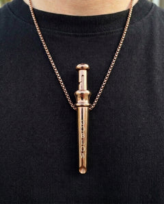 GoBlow Pendant MKII in Rose Gold, worn on the chest — machined stainless EDC capsule pendant