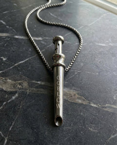 GoBlow Pendant MKII in Steel, on marble — machined stainless EDC capsule pendant